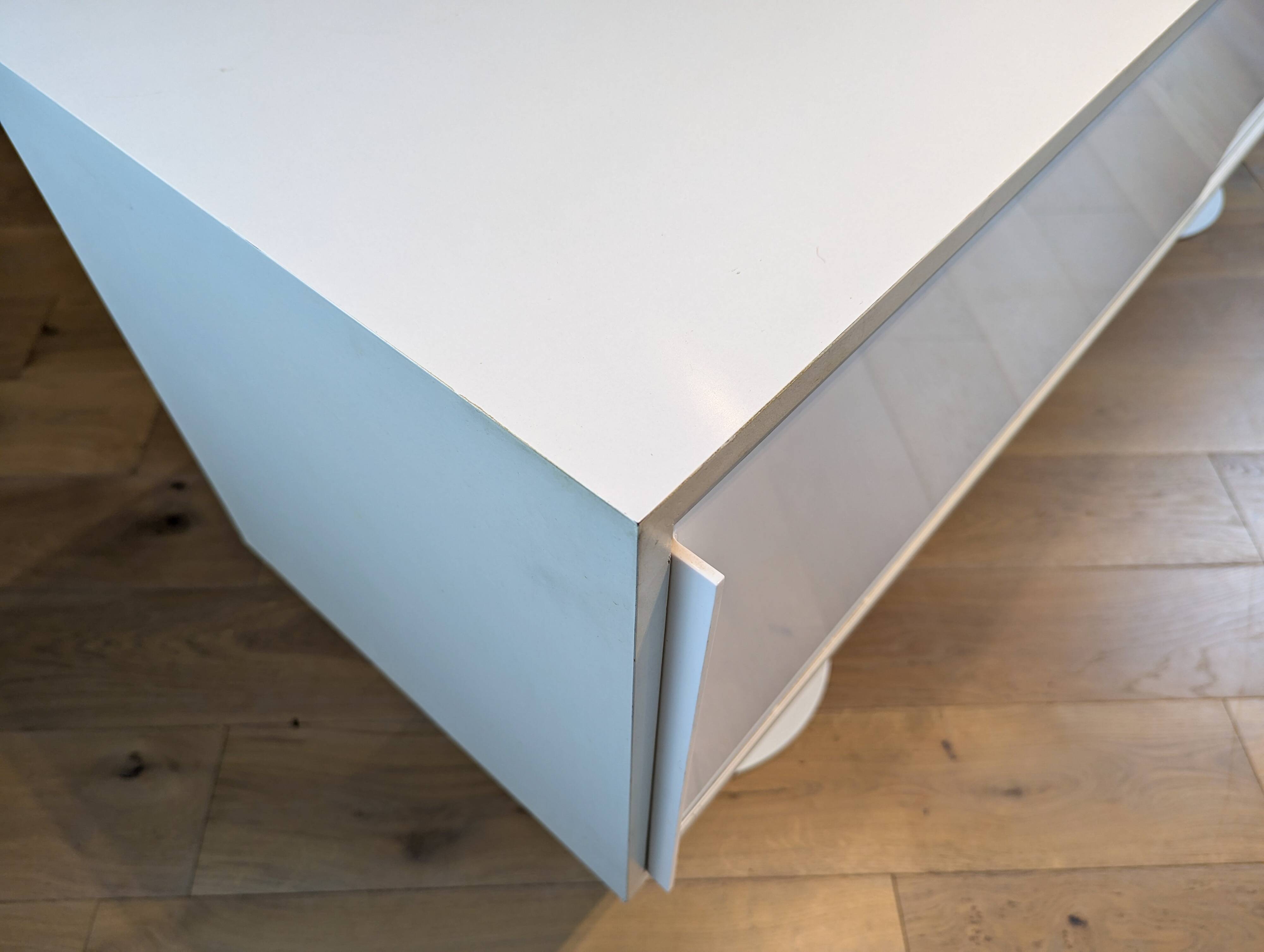 A vintage mid century space age sideboard with white sliding doors