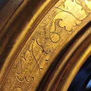 Florentine arched mirror in gilded wood with gold leaf.