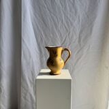 Large antique handmade ochre yellow jug with a pink flower pattern.