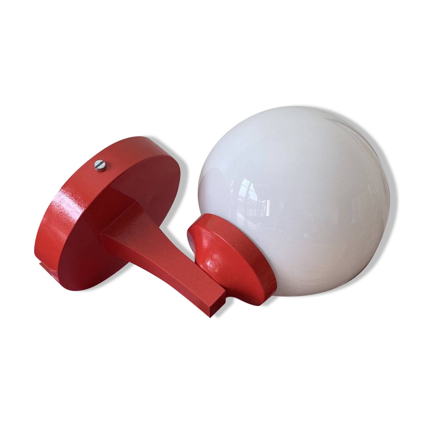 Red plastic wall light with a white opaline glass globe.