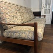 Vintage 3-seater wooden sofa with sculptural backrest.