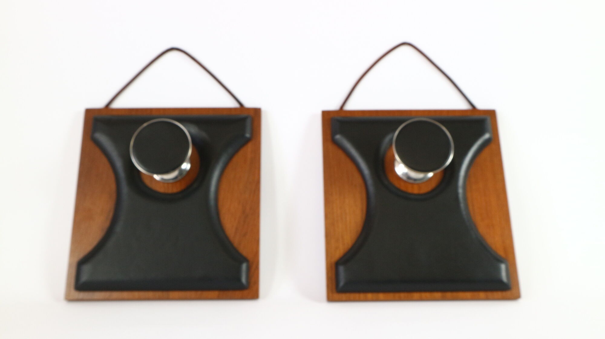 Two coat hangers, wood, leather and black leather, 70s
