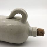 Old hot water bottle in glazed stoneware, gray color.