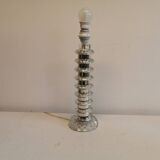 Table lamp made of transparent crystal glass and silver colored spacers.
