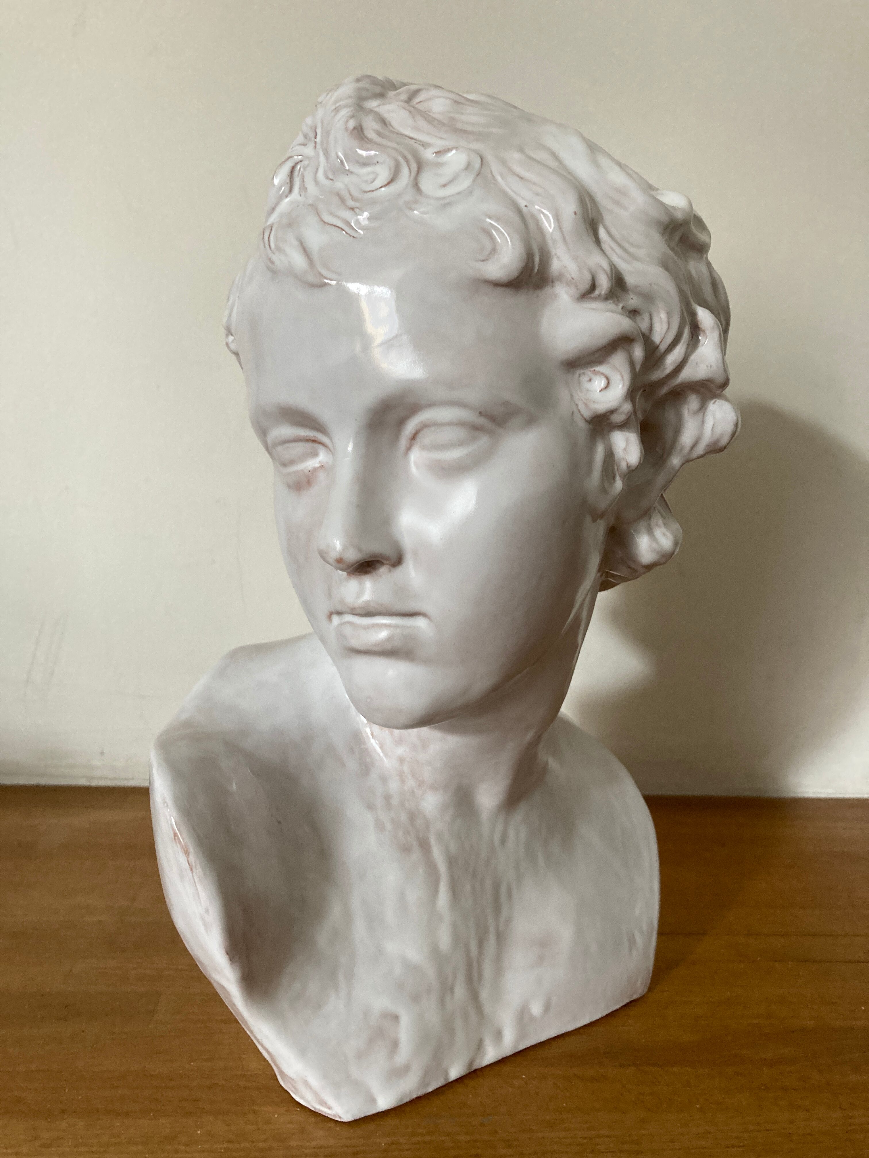 White enamelled terracotta Eros bust