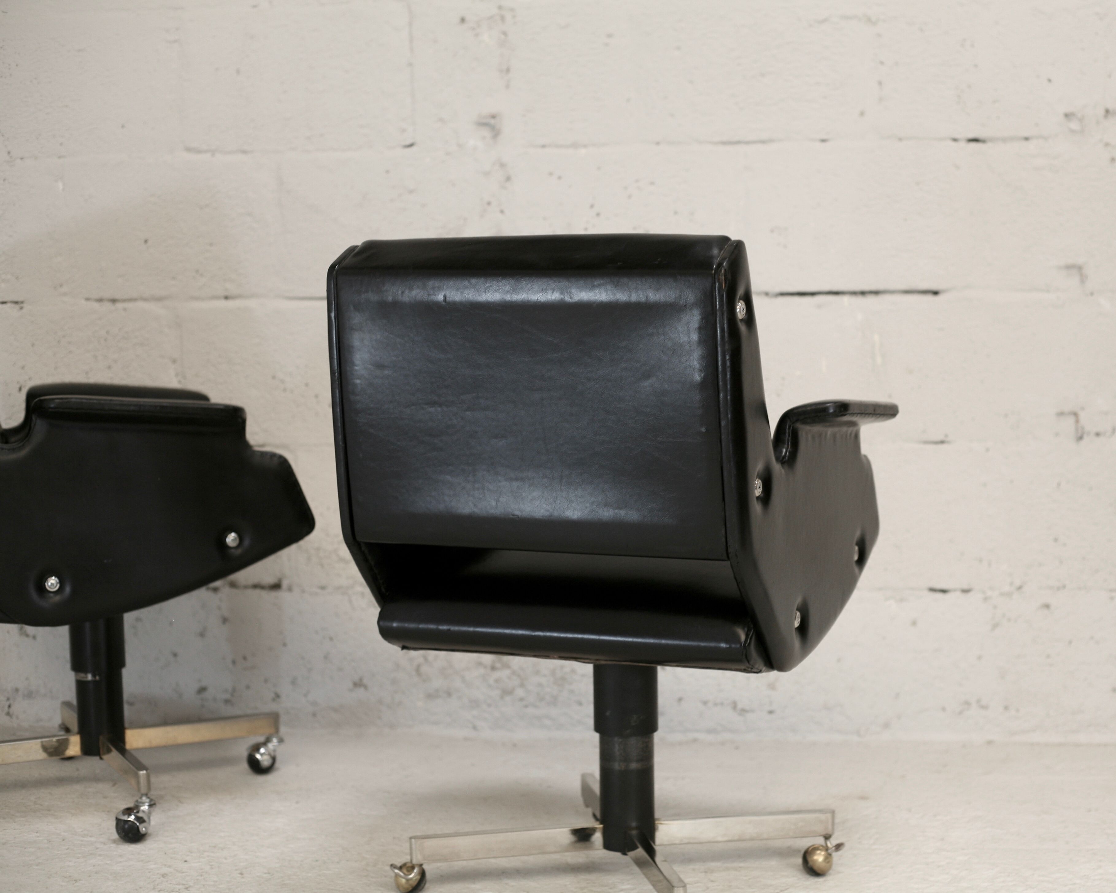 Pair of swivel armchairs, imitation leather and steel, Italy, circa 1960.