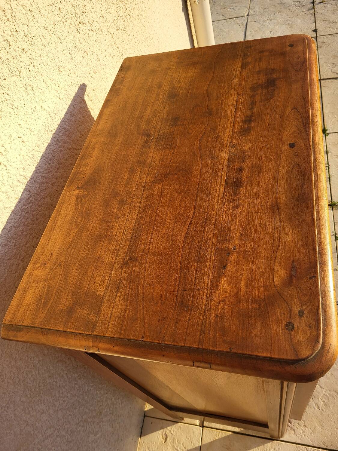 Furniture with a cherry wood door.