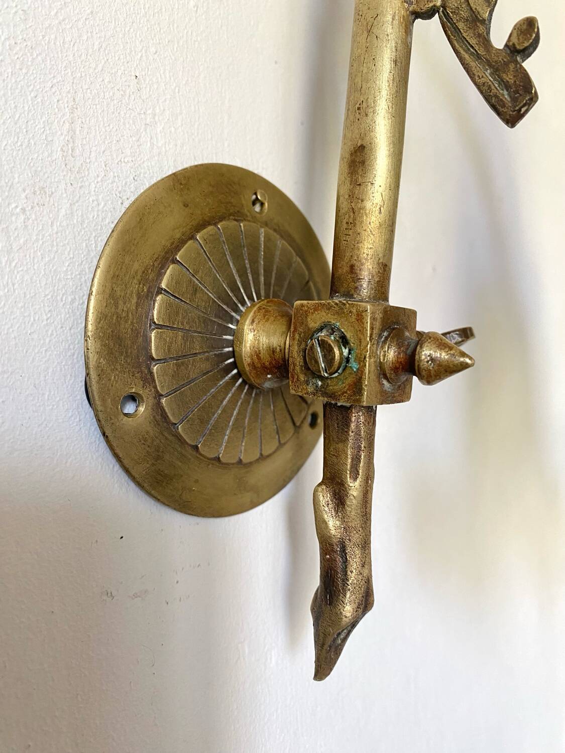Antique brass wall light with glass shade.