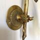 Antique brass wall light with glass shade.