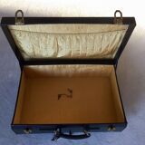 Leather suitcase black edges and handle saddle stitching