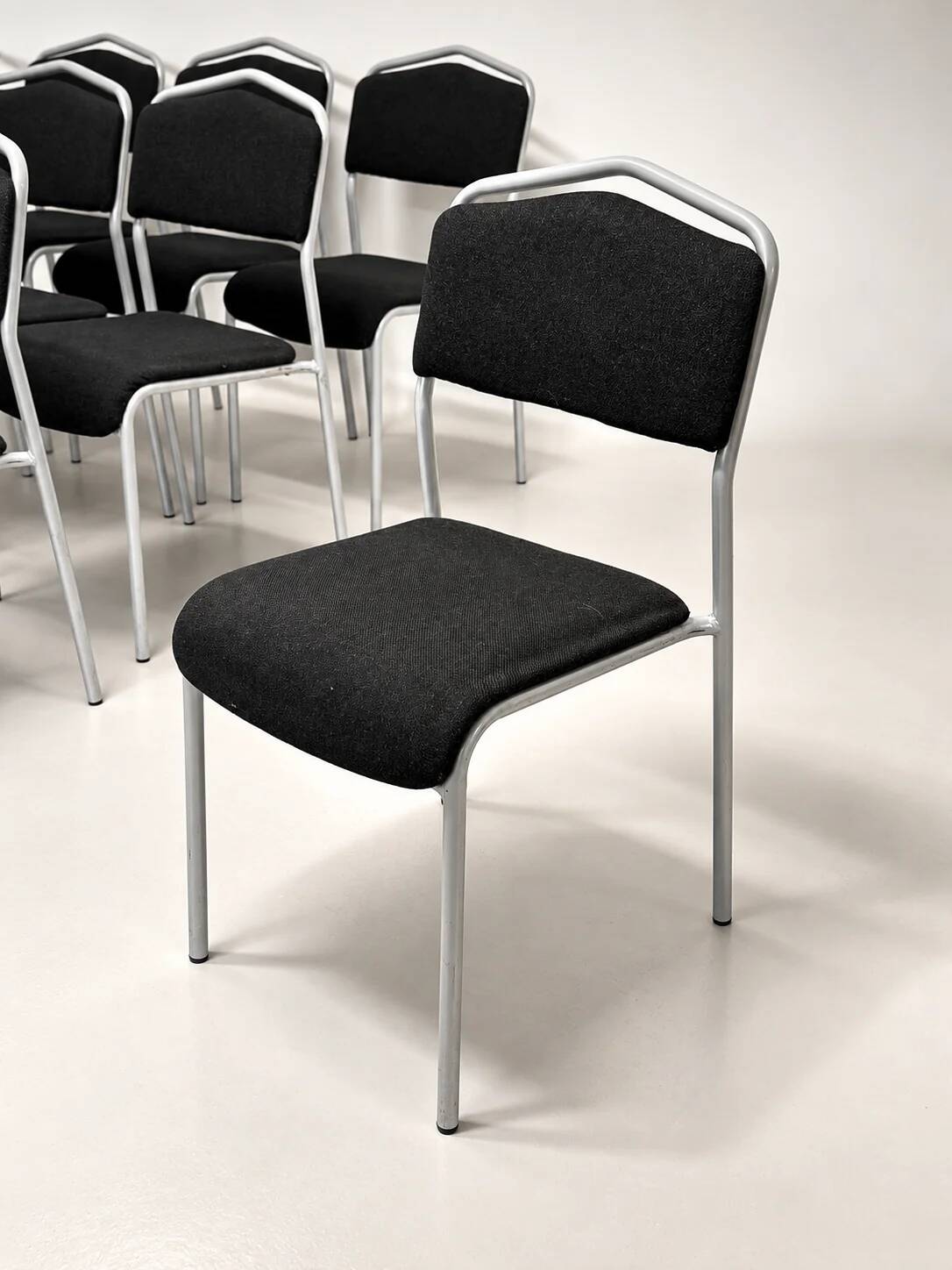 Grey steel chair and black fabric