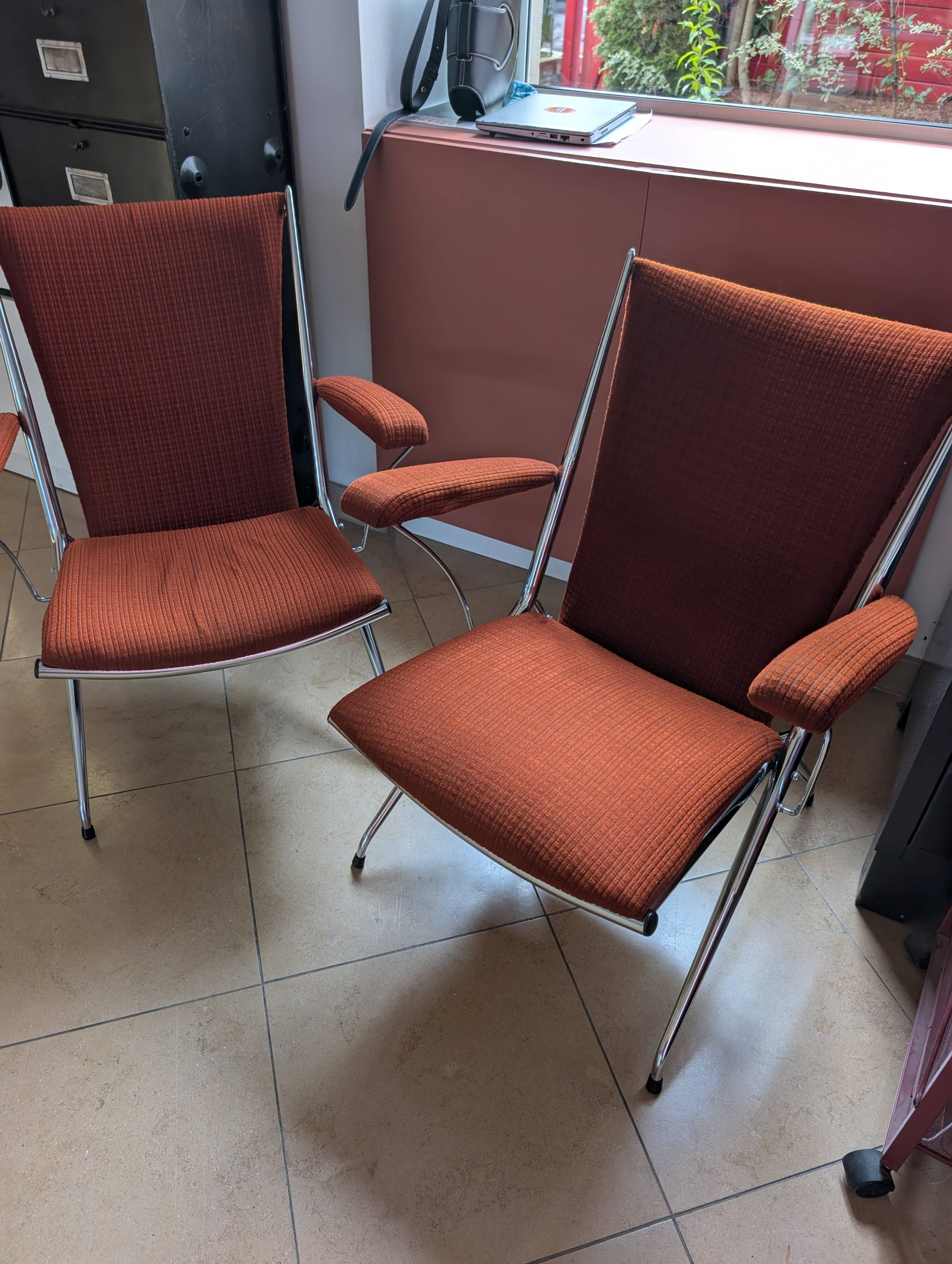Pair of vintage folding chairs in terracotta fabric.
