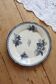 Flat plate iron earth Onnaing - Blue-black plant decoration on ivory background