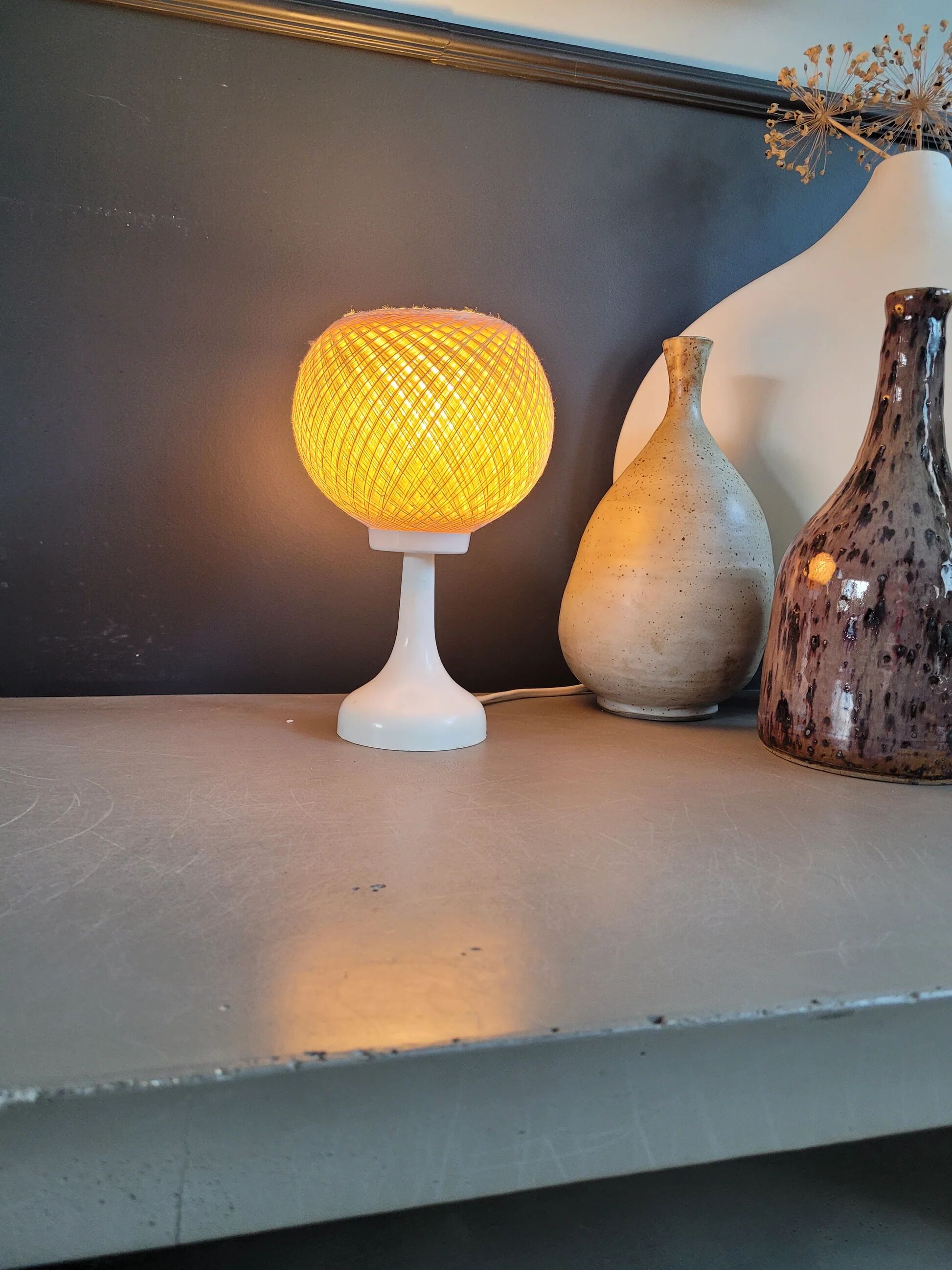 60's table lamp with tulip base and stretched wire shade.