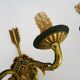 Pair of double-light Empire style arrow wall lights in bronze. Early 20th century