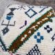 Berber floor pouf: Handwoven Moroccan wool cushion.