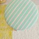 Antique tripod stool with striped seat.