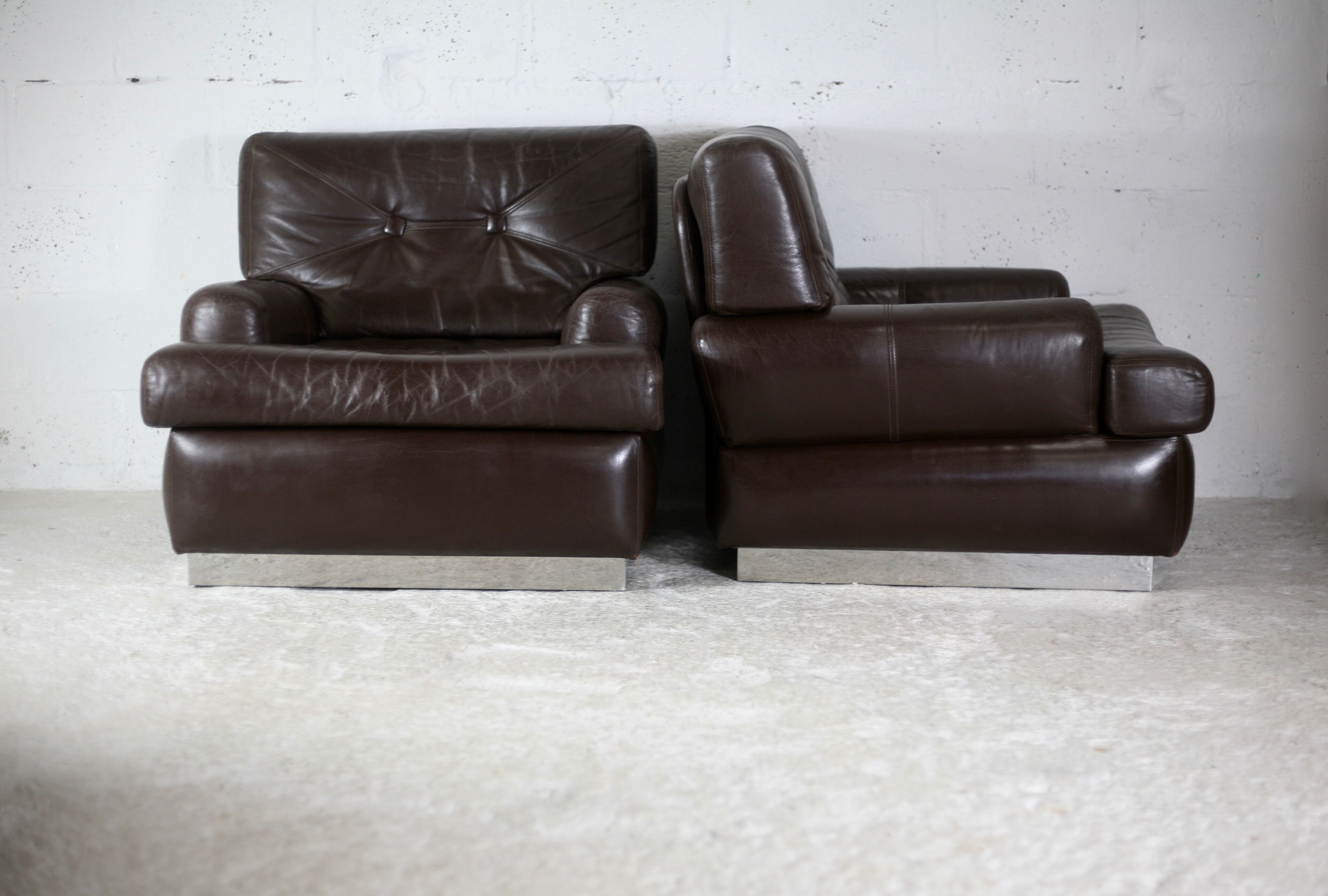 Pair of armchairs brown leather base stainless steel, France, circa 1970