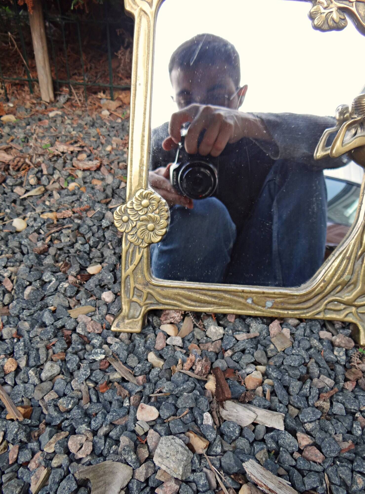 Art Nouveau mirror in gilded brass with a woman figure emerging from a vintage frame