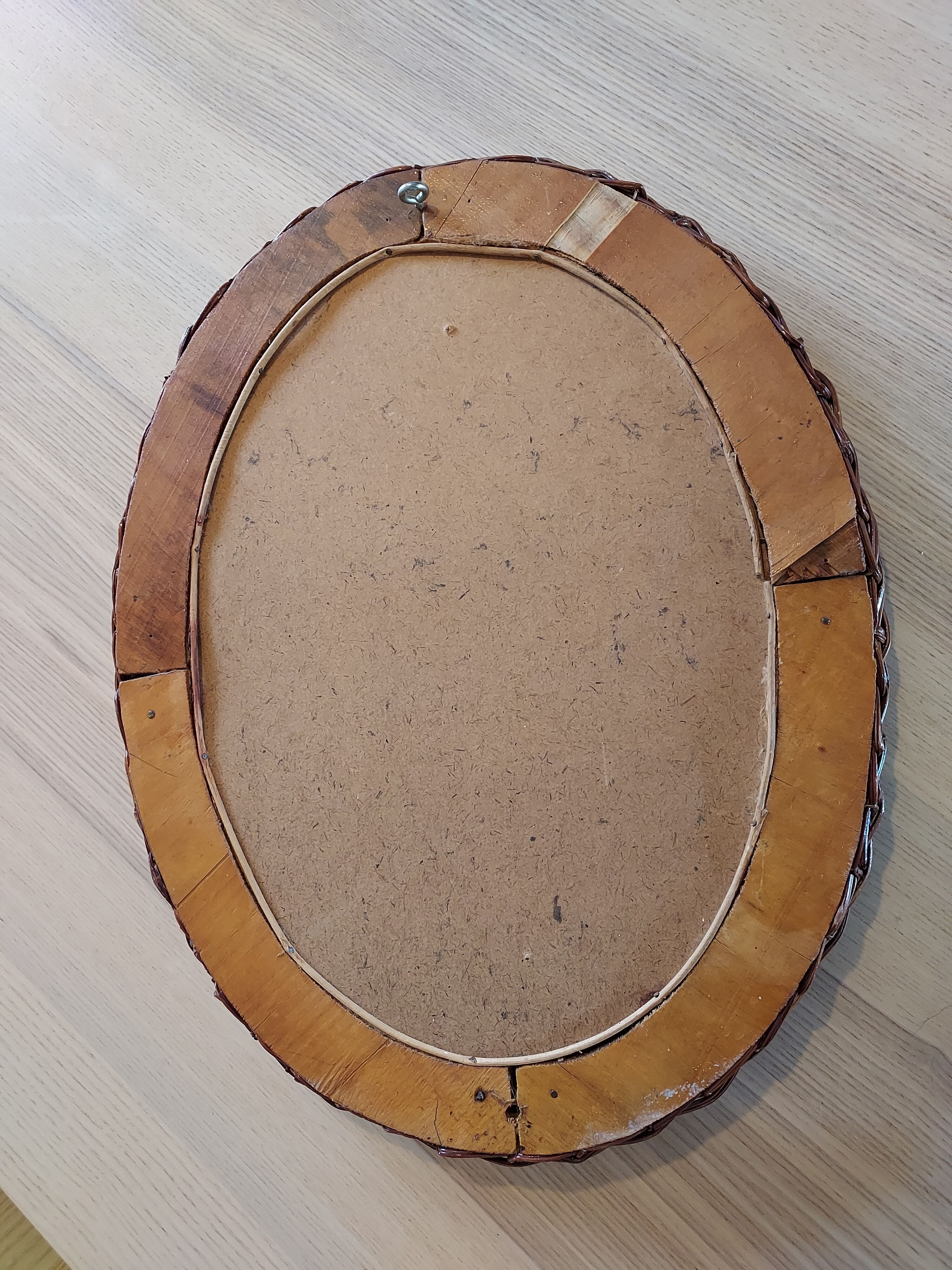 Oval mirror in dark rattan