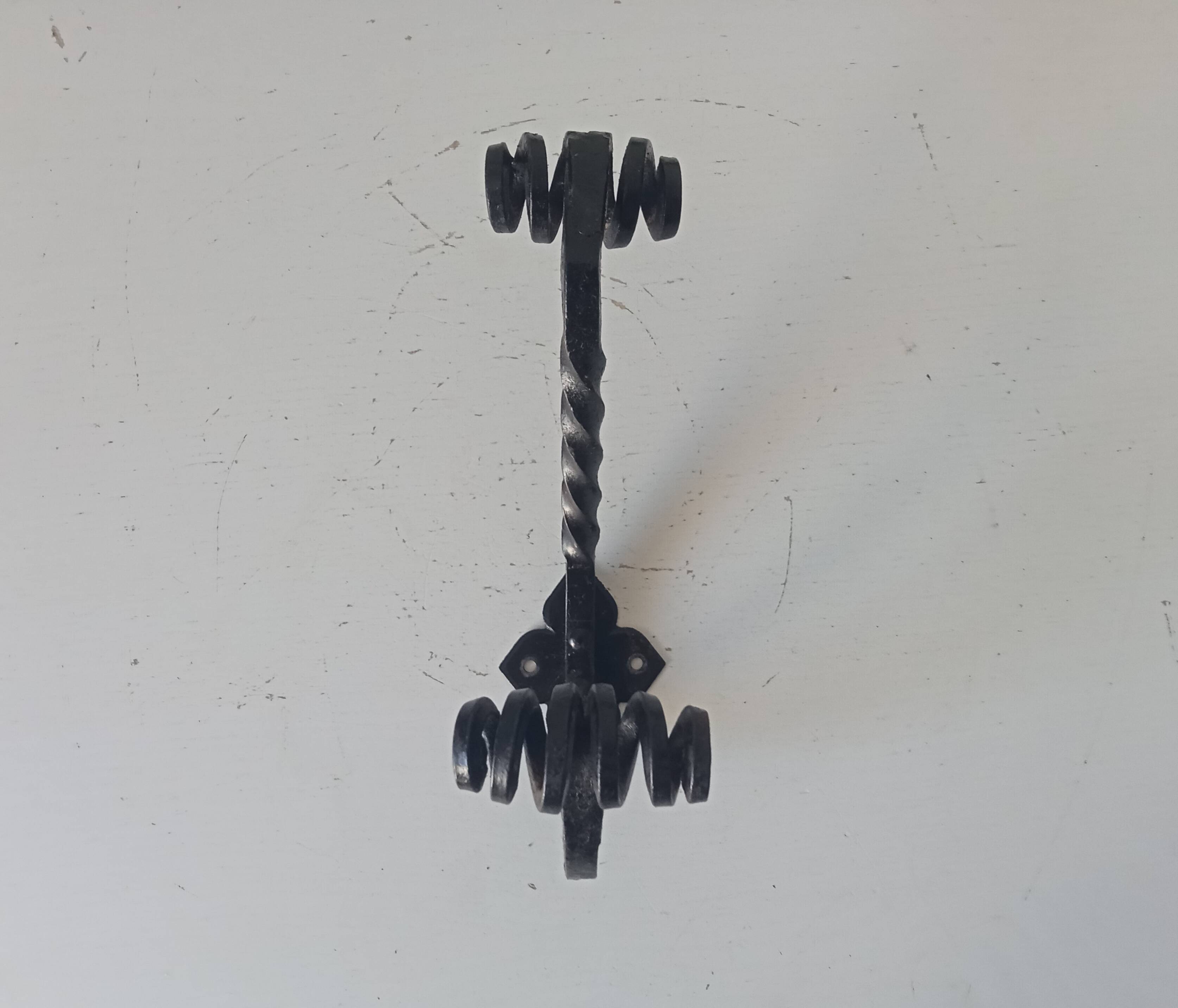 Brutalist wall coat rack in wrought iron.