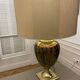 Bronze table lamp with a golden shade.