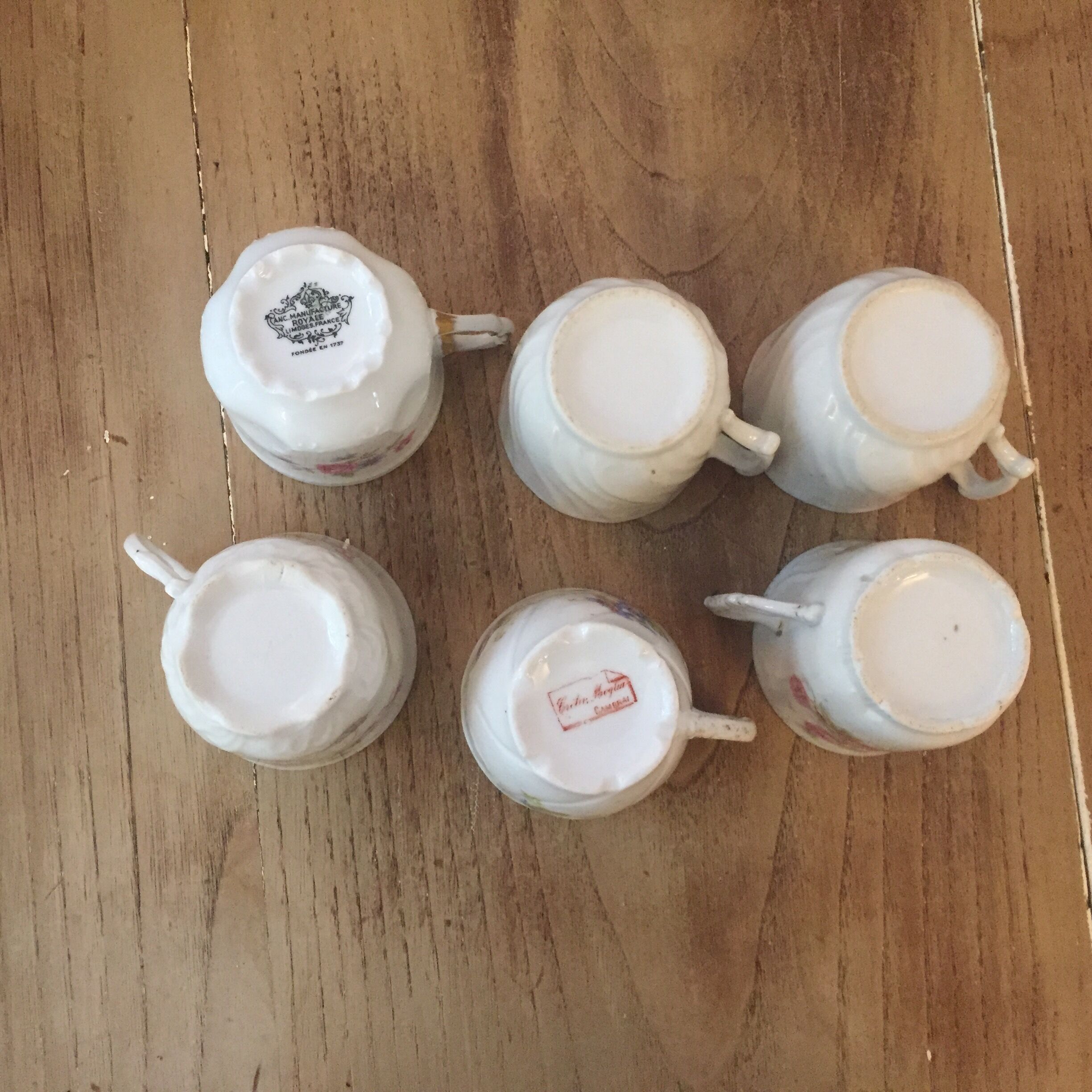 6 antique cups and mismatched saucers