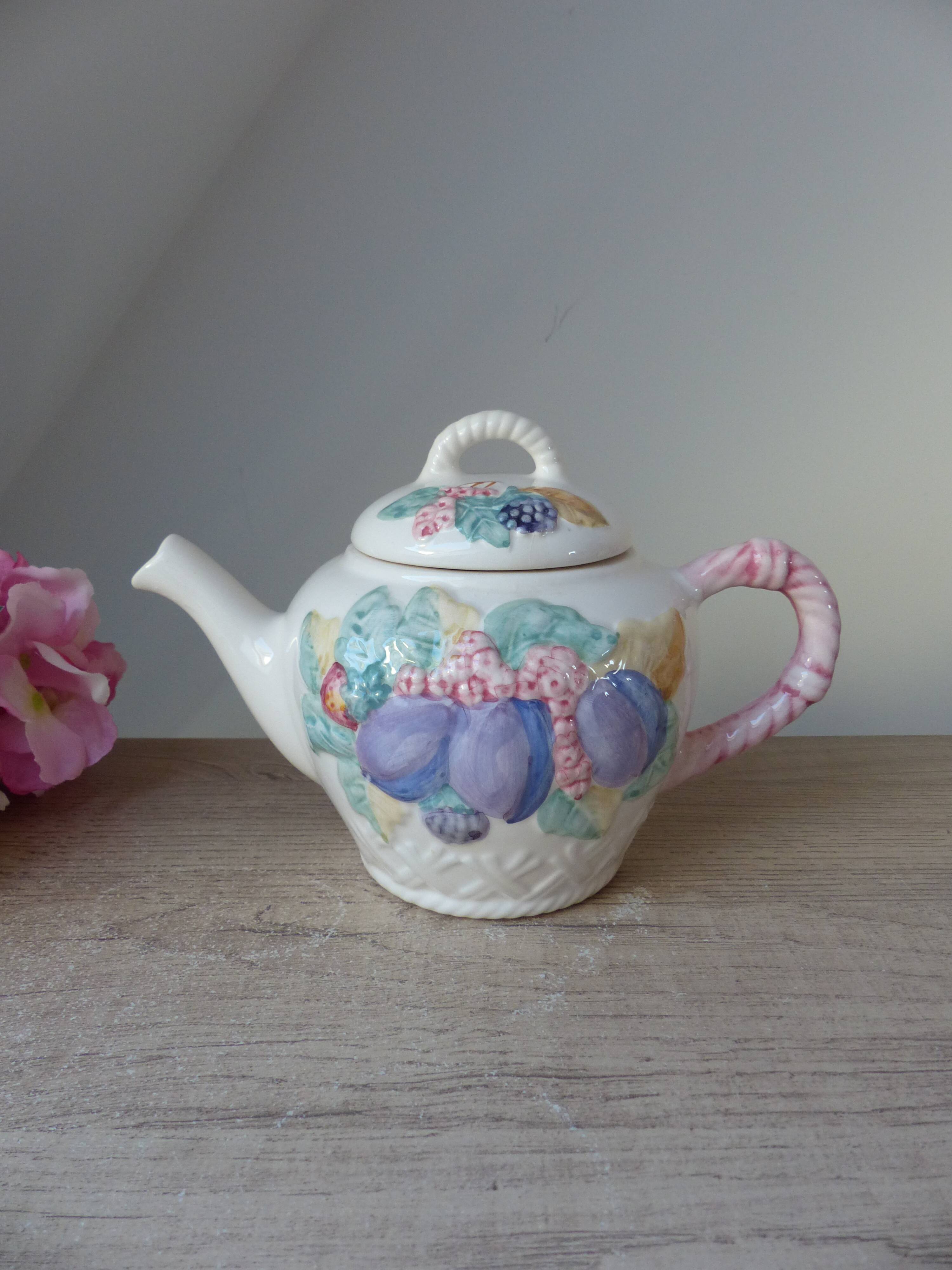Old ceramic teapot in the shape of a basket of fruits from the garden