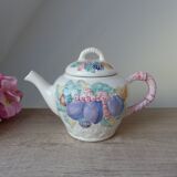 Old ceramic teapot in the shape of a basket of fruits from the garden