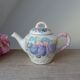 Old ceramic teapot in the shape of a basket of fruits from the garden