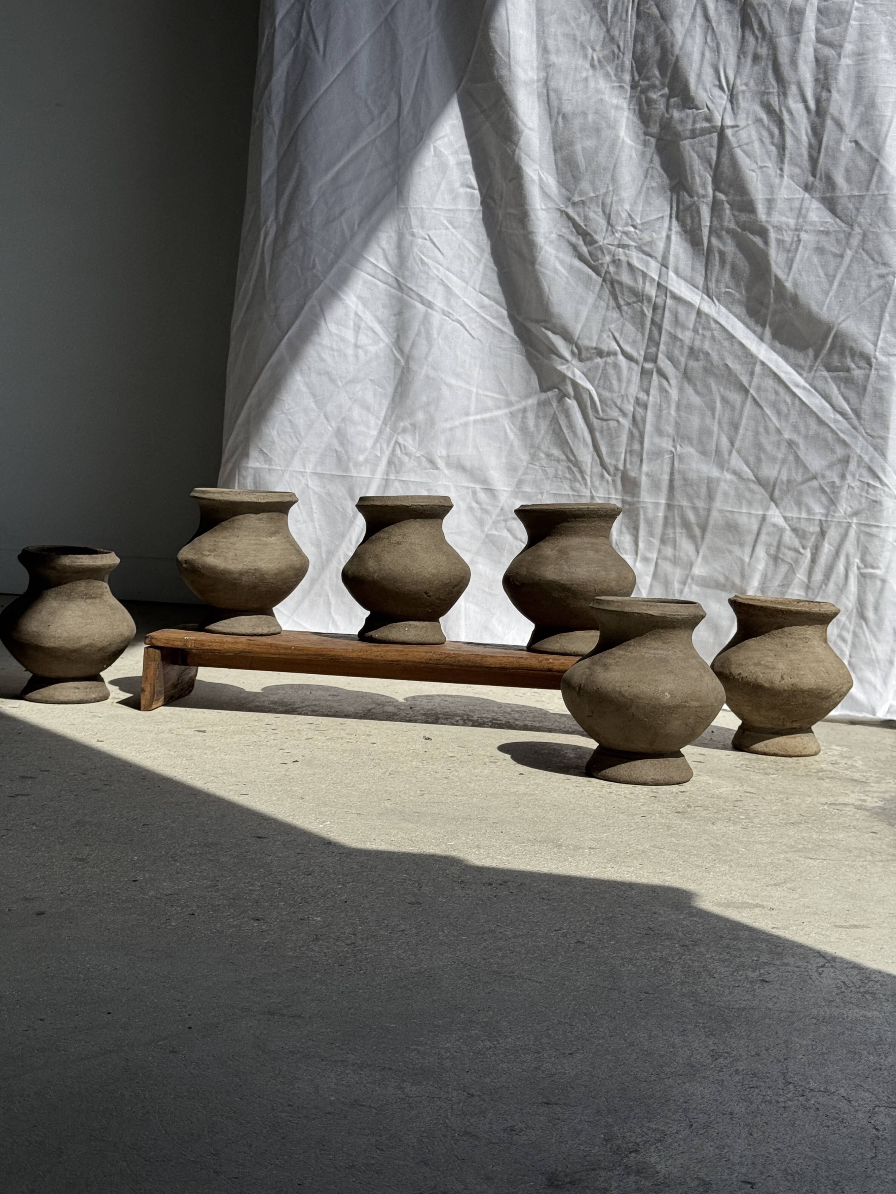 Small brutalist handcrafted terracotta vase with a pedestal, Indonesian, H19 D17.