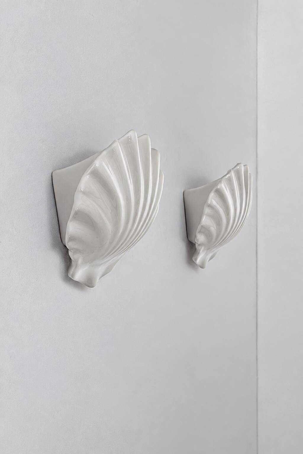 Vintage pair of white porcelain wall lights, France 1970.