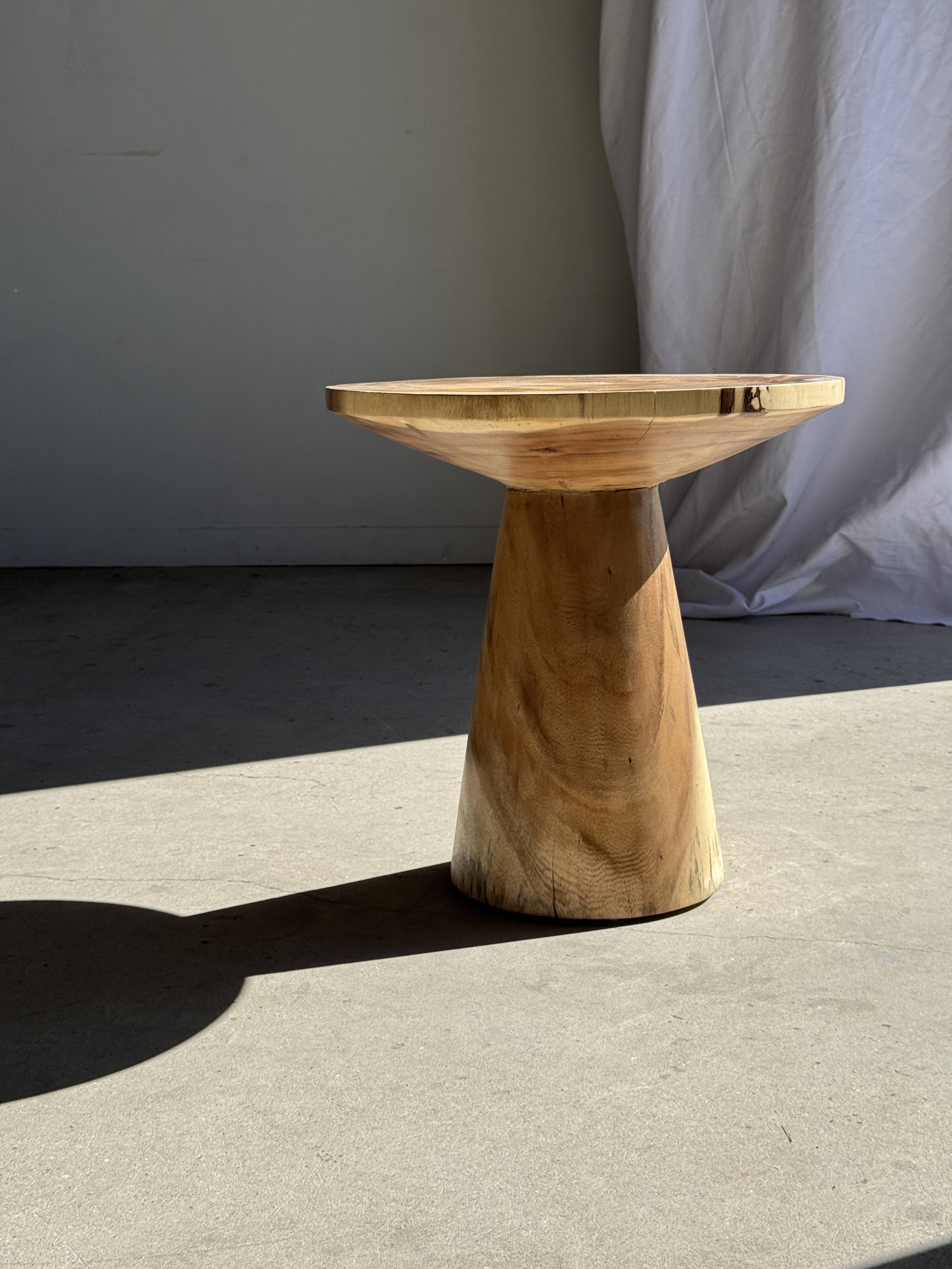 Natural solid suar side table (monoxyle) with a minimal conical base.