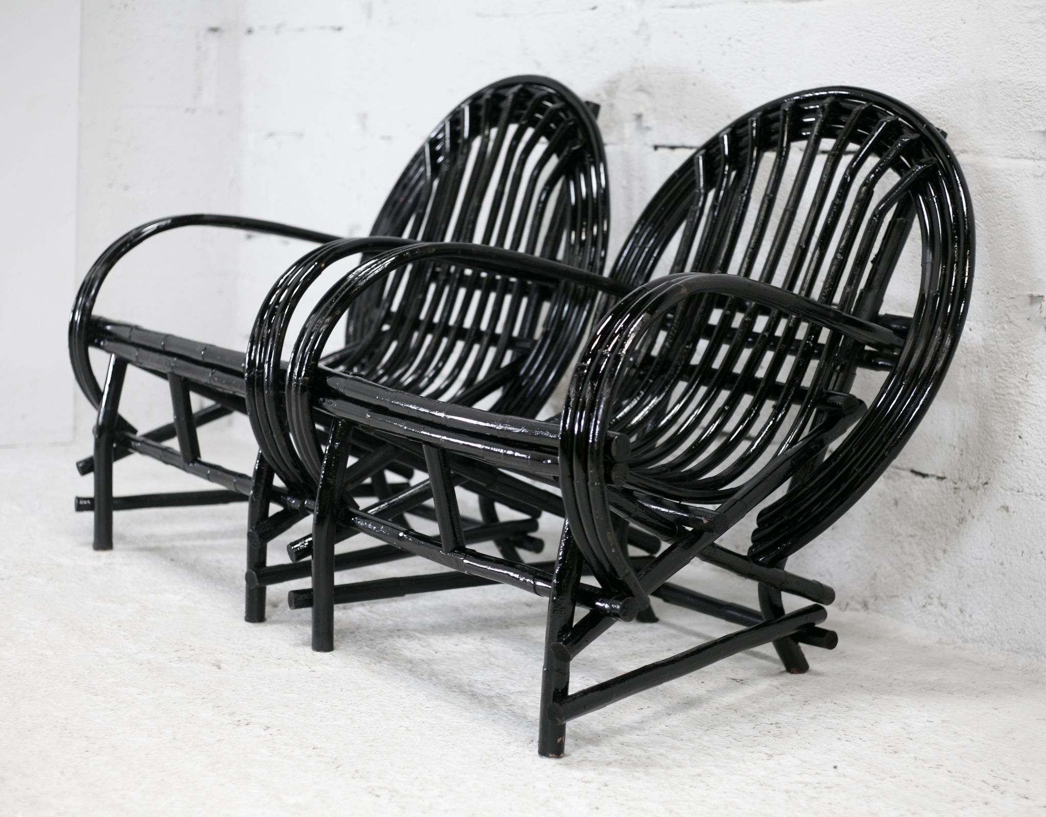 Pair of black lacquered rattan armchairs. France, cira 1960.
