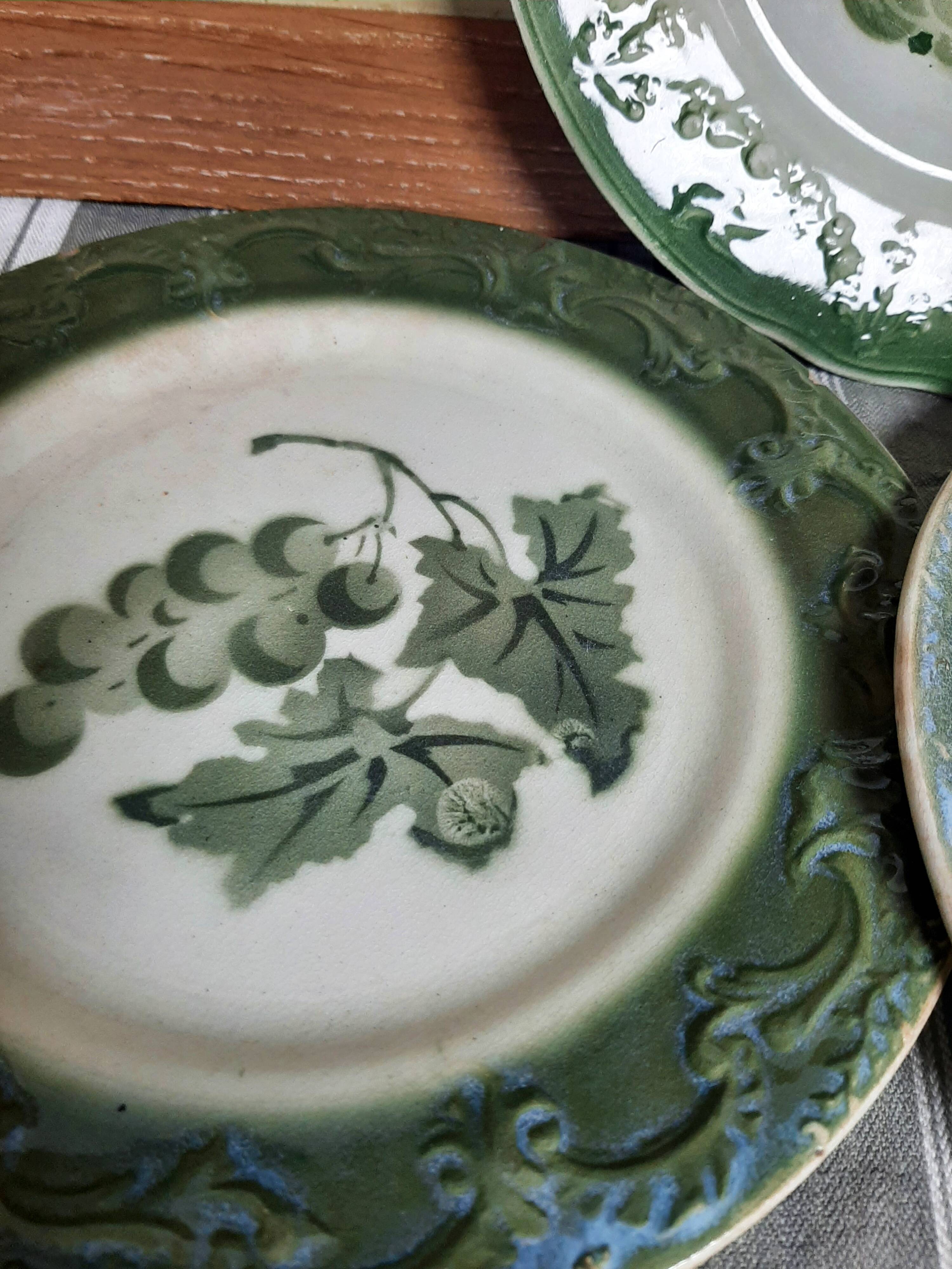 Antique earthenware plates with fruit decoration.