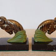 Art Deco pair of bookends with ram's heads, patinated metal and black marble.
