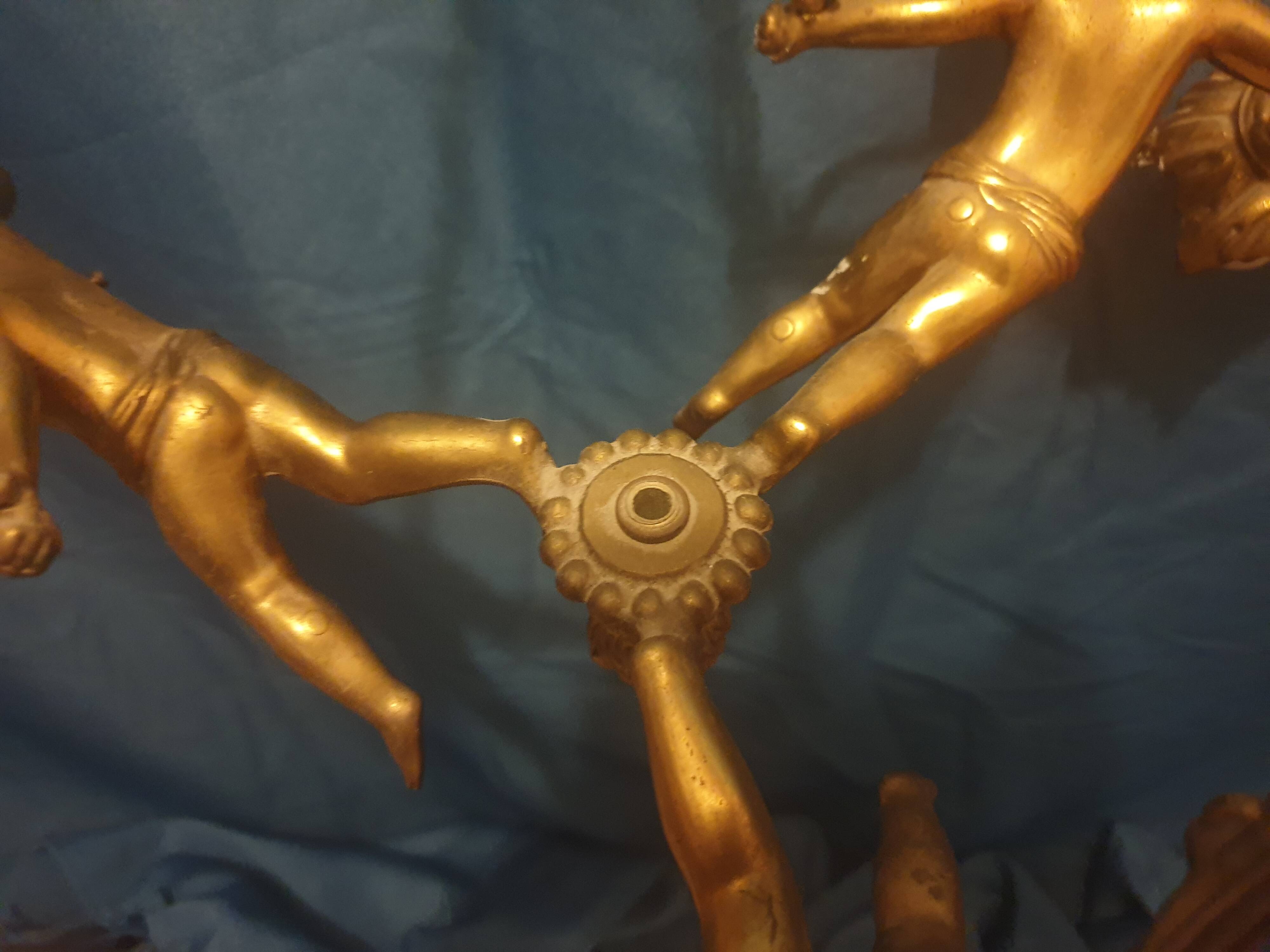 Antique chandelier decorated with cherubs and putti angels taken from the attic