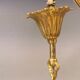 Older brass alloy chandelier with three light sources.