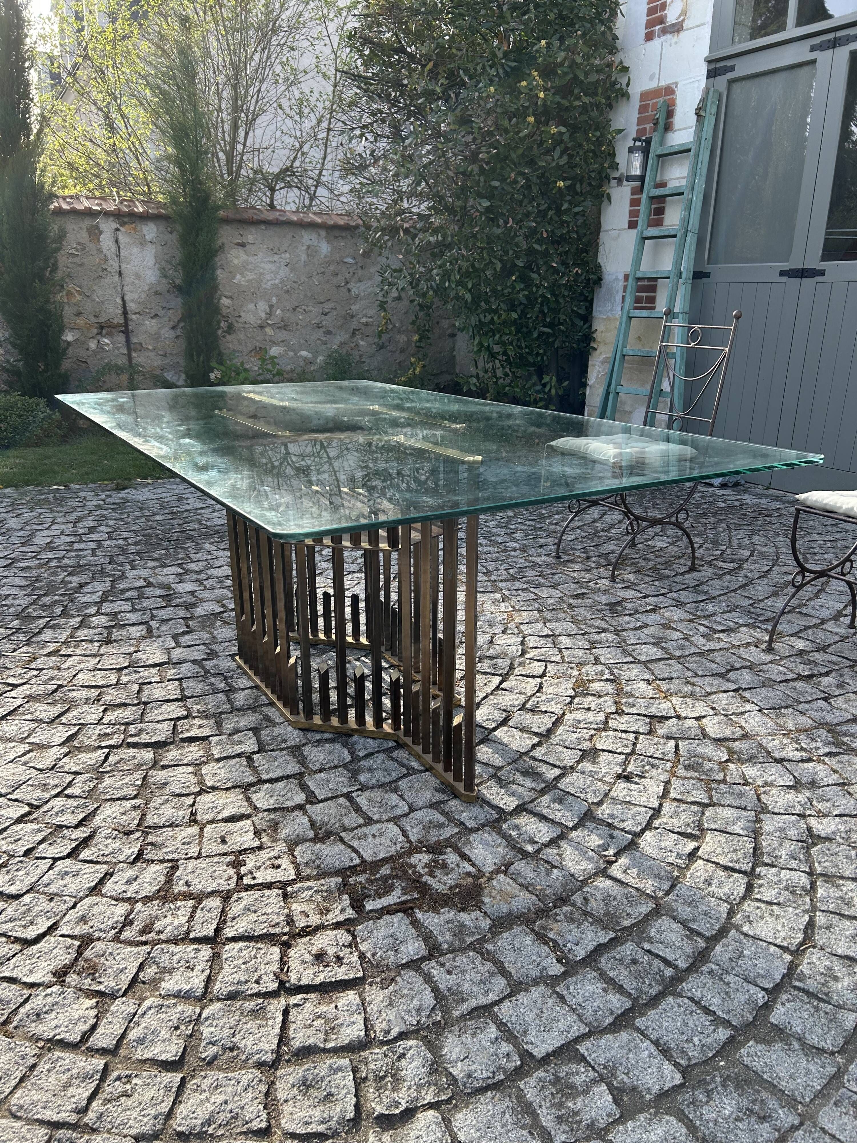 Dining table with brass base in the style of Willy Rizzo, 1970s.