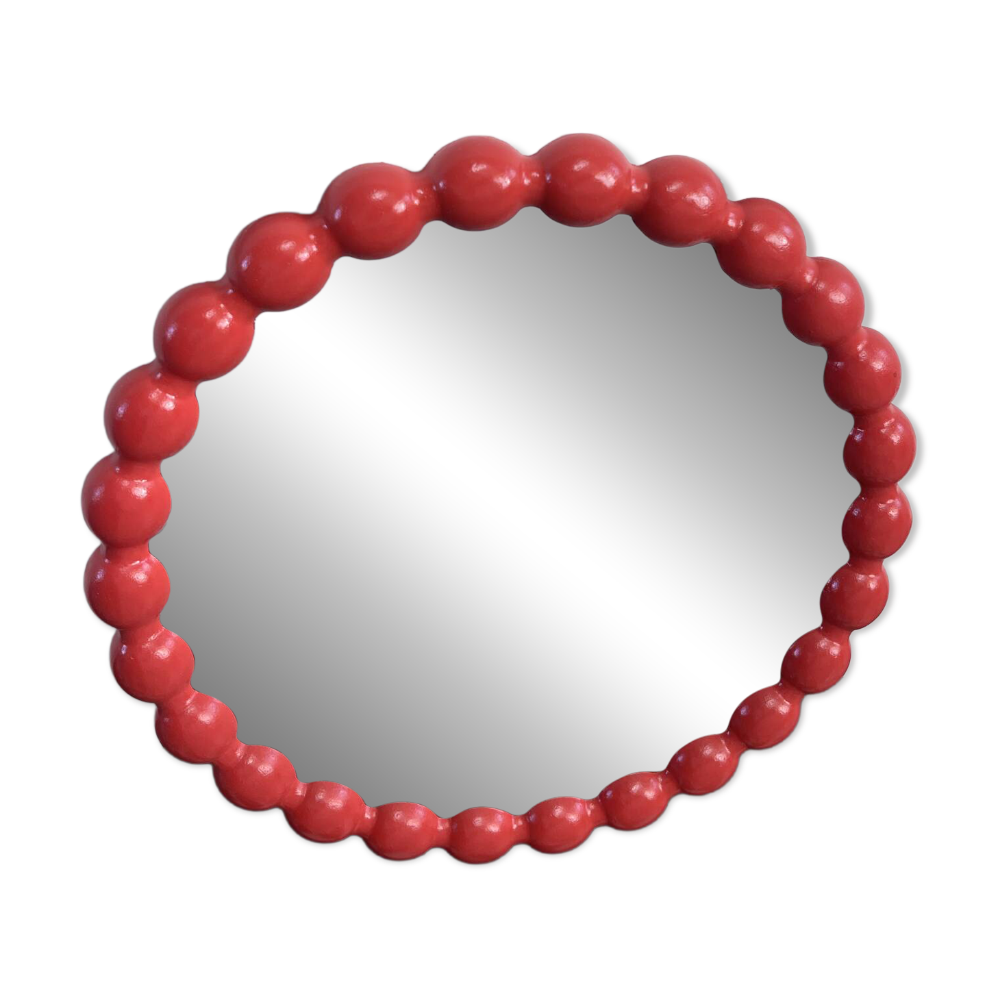 Round wall mirror with red beads in vintage retro design style.