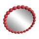 Round wall mirror with red beads in vintage retro design style.
