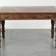 Antique English writing desk from the 19th century with a red leather top