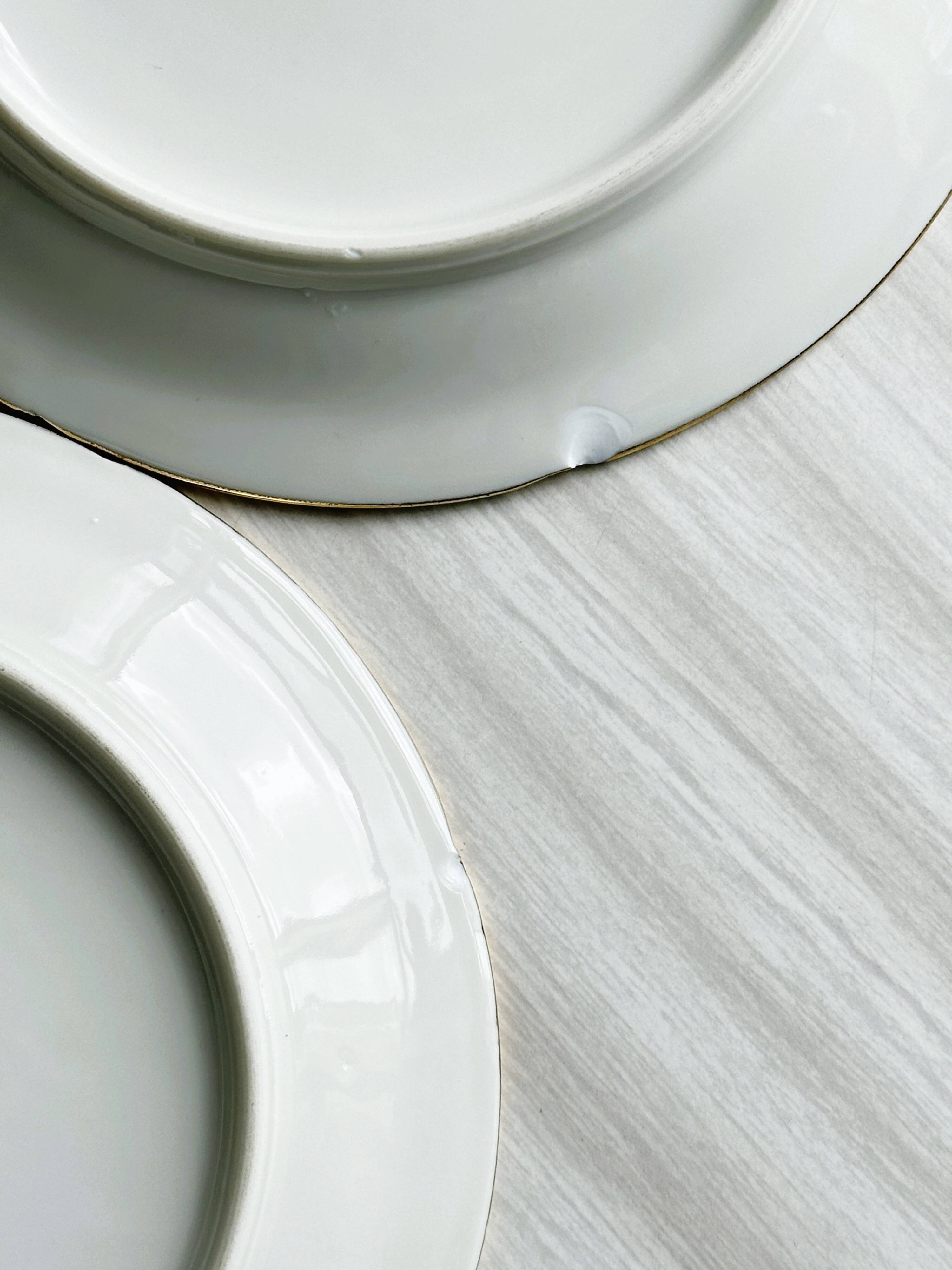 12 Limoges porcelain dessert plates, gold decoration.