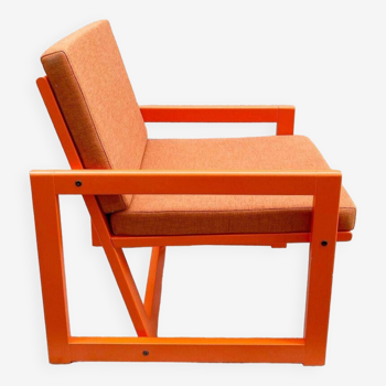 Orange designer armchair by Terence Conran