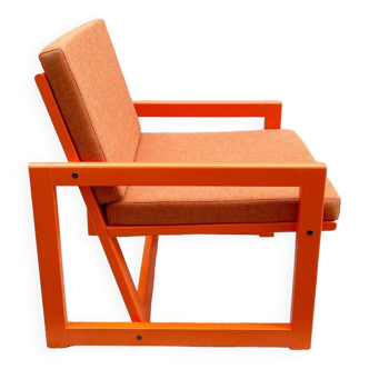 Orange designer armchair by Terence Conran