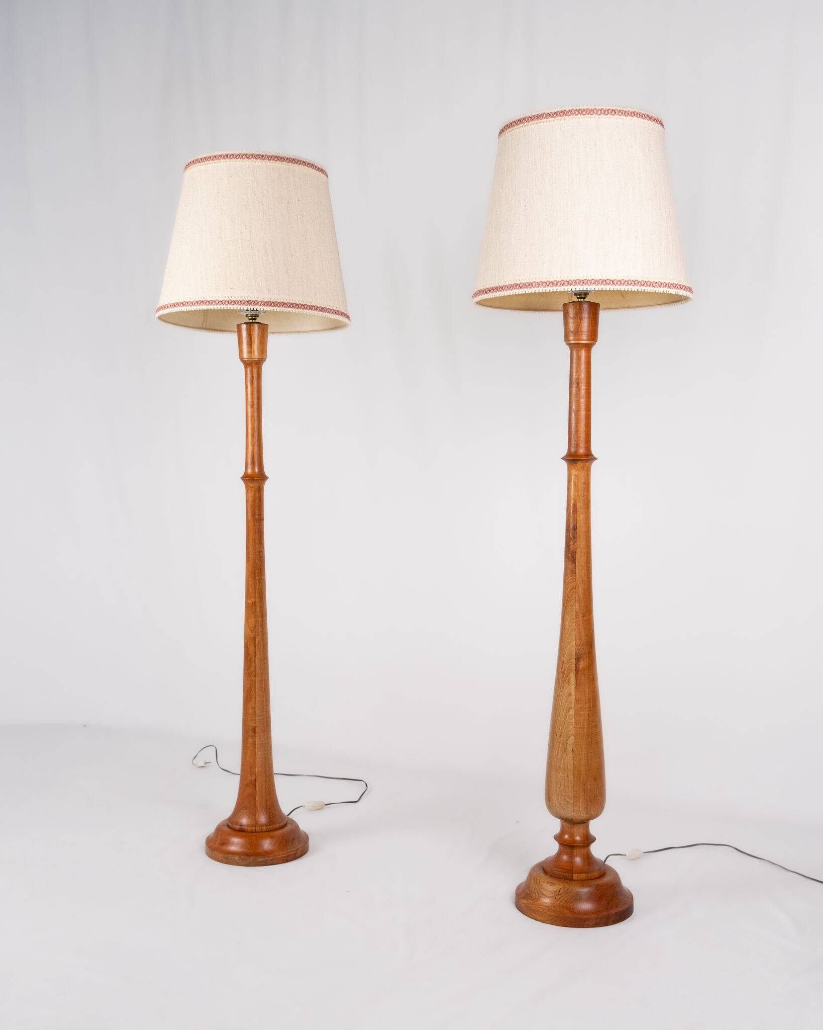 Pair of turned wooden floor lamps in Art Deco style, France, mid-20th century.