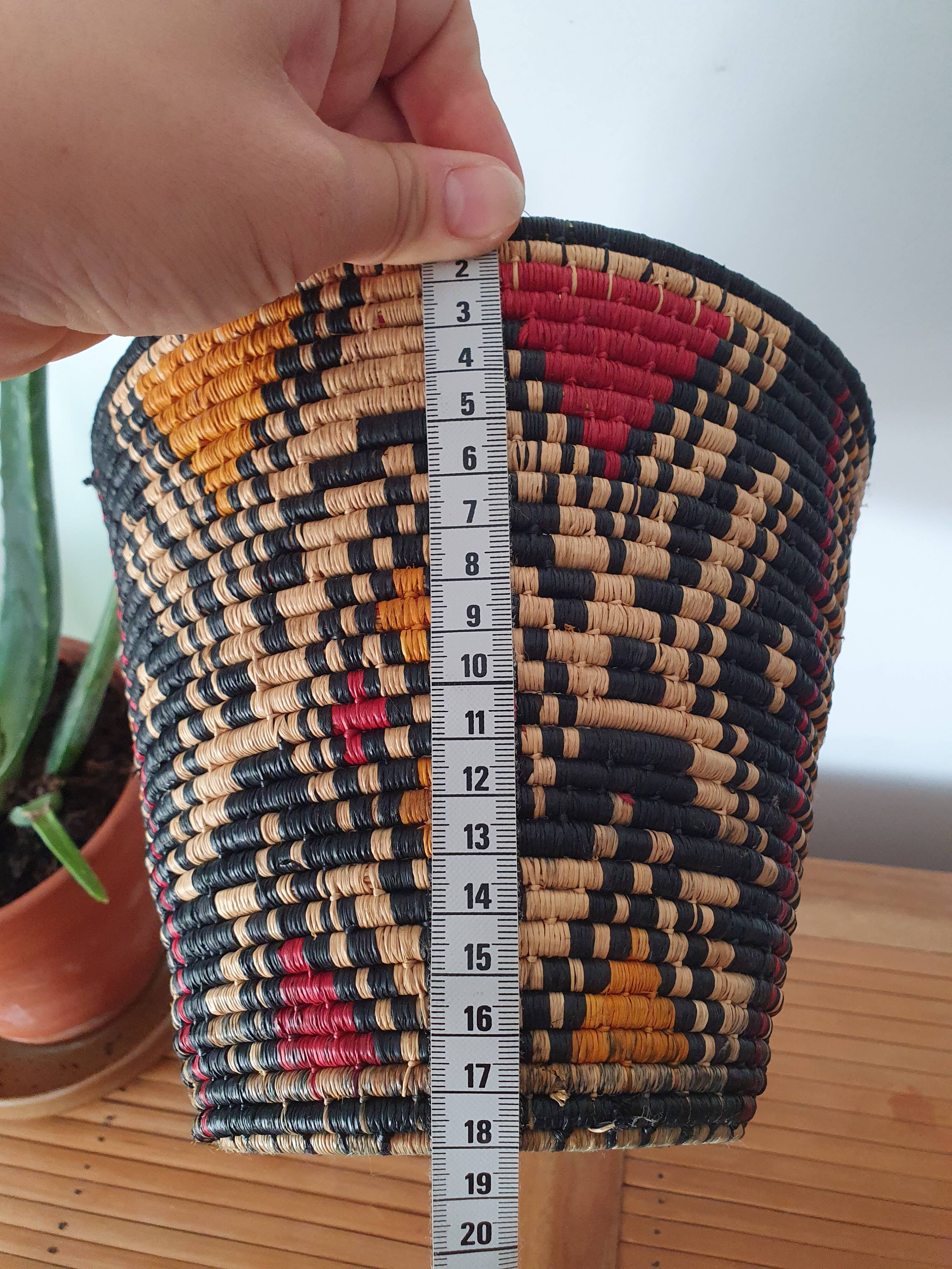 Ethnic basket in multicolored braided straw
