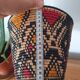 Ethnic basket in multicolored braided straw