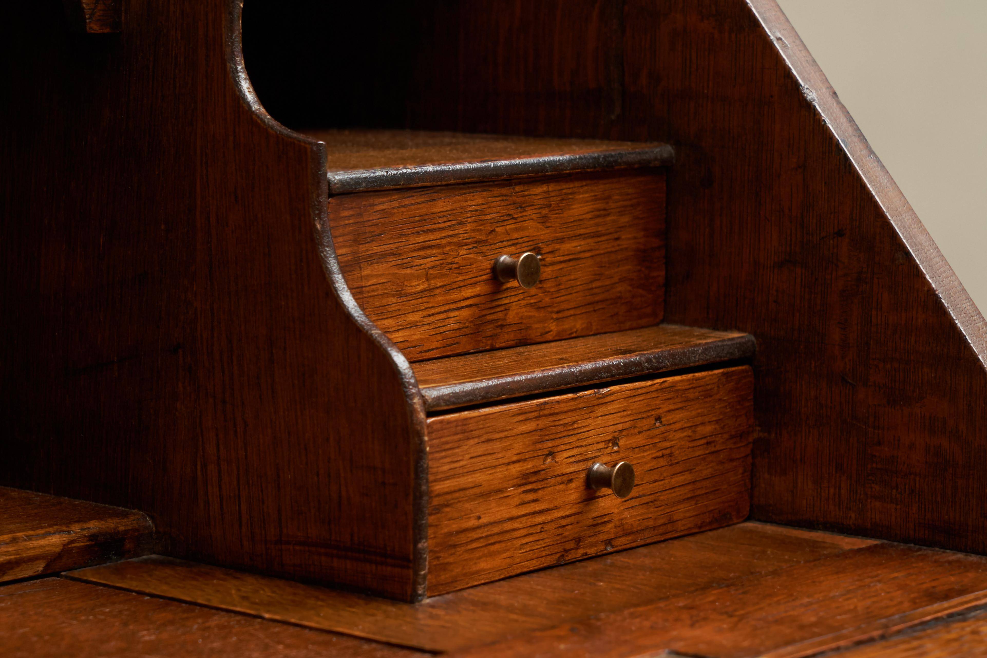 Antique English oak secretary with drop-down front.