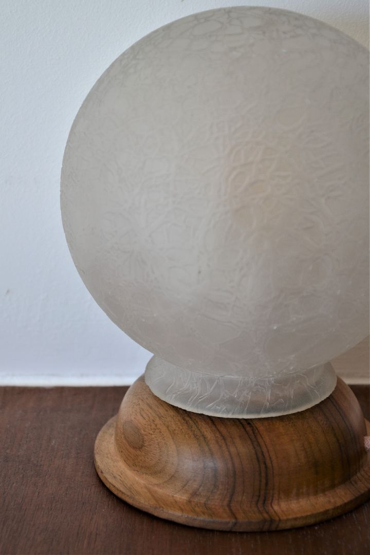 White glass globe table lamp with geometric reliefs